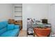 Home office with blue futon, glass desk, and a closet with built in shelves at 120 Diploma Dr, Ladson, SC 29456