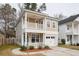 Attractive two-story home with a double balcony, integrated garage, and lush landscaping at 120 Diploma Dr, Ladson, SC 29456