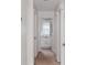 Bright hallway leading to a bathroom with a white vanity at 120 Diploma Dr, Ladson, SC 29456