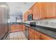 Well-lit kitchen features stainless steel appliances, stylish backsplash, and tiled floors at 120 Diploma Dr, Ladson, SC 29456