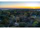 Aerial view of the property in a tree filled neighborhood, highlighted by a beautiful sunset at 1235 Sunset Dr, Charleston, SC 29407