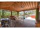 Spacious back porch with fans, outdoor seating, a picnic table, and a view of the pool at 1235 Sunset Dr, Charleston, SC 29407