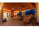 Inviting back porch with ceiling fans, TV, picnic table, and cozy seating for relaxing and entertaining at 1235 Sunset Dr, Charleston, SC 29407