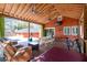 Relaxing back porch with fans, lighting, seating, picnic table, and a view of the pool at 1235 Sunset Dr, Charleston, SC 29407