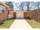 A detached garage with a white door and red brick exterior is accessed via a concrete driveway at 1235 Sunset Dr, Charleston, SC 29407