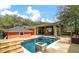 Outdoor pool and entertainment area with decking, covered seating and lush greenery at 1235 Sunset Dr, Charleston, SC 29407
