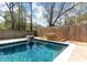 Backyard pool featuring tanning ledge, wooden deck, fire feature, and privacy fence at 1235 Sunset Dr, Charleston, SC 29407