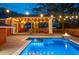 Inviting backyard pool and covered deck area featuring ample seating and charming string lights creating the perfect outdoor retreat at 1235 Sunset Dr, Charleston, SC 29407