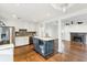 Open kitchen layout with stainless steel appliances, white cabinetry, island, and hardwood floors at 1245 Forestwood Dr, Charleston, SC 29407