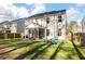 Backyard showcasing a screened porch, fenced perimeter, and inviting blue chairs around a fire pit at 133 Caleb Ct, Ladson, SC 29456