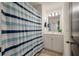 Bright bathroom featuring a vanity with sink, a mirror, and a blue and white striped shower curtain at 133 Caleb Ct, Ladson, SC 29456