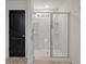 Shower and toilet area with tiled floors, glass door on shower, and black door at 133 Caleb Ct, Ladson, SC 29456