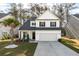 Charming two-story home features a well-manicured lawn, a two-car garage, and lovely landscaping at 133 Caleb Ct, Ladson, SC 29456