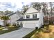 Charming home with a well-maintained lawn, a two-car garage, and a welcoming front porch at 133 Caleb Ct, Ladson, SC 29456