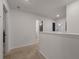 Second floor hallway with neutral carpet and view to other bedrooms at 133 Caleb Ct, Ladson, SC 29456