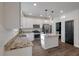 Stylish kitchen featuring an island, stainless steel appliances, white cabinets, and granite countertops at 133 Caleb Ct, Ladson, SC 29456