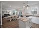 Kitchen island with a sink and a dining area, with the Gathering room in the distance at 133 Caleb Ct, Ladson, SC 29456