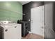 Functional laundry room featuring modern appliances and a contrasting black and green color scheme at 133 Caleb Ct, Ladson, SC 29456
