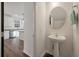 Charming powder room with a pedestal sink and views into the adjacent kitchen at 133 Caleb Ct, Ladson, SC 29456