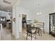 Inviting dining area showcasing modern wood-look floors, a chandelier, and views of the adjacent kitchen at 145 Wild Holly Dr, Moncks Corner, SC 29461