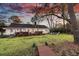 Spacious backyard featuring a wooden deck, a fire pit, and mature trees, ideal for relaxation at 1522 N Pinebark Ln, Charleston, SC 29407