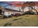 Expansive backyard with a charming brick home, wooden deck, and lush lawn at sunset at 1522 N Pinebark Ln, Charleston, SC 29407