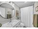 Bathroom featuring a white single sink vanity, round mirror, neutral paint and shower with white curtain at 1522 N Pinebark Ln, Charleston, SC 29407