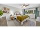 Cozy bedroom with wicker headboard, neutral walls, and a window overlooking a wooded outdoor view at 1522 N Pinebark Ln, Charleston, SC 29407