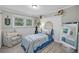 Cozy bedroom featuring a patterned chair, comfortable twin bed and natural light from large windows at 1522 N Pinebark Ln, Charleston, SC 29407