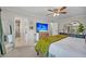Spacious bedroom featuring a ceiling fan, TV, and adjacent bathroom with a glass-enclosed shower at 1522 N Pinebark Ln, Charleston, SC 29407