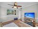 Bedroom featuring a TV, a large painting, a ceiling fan, and a beach view displayed on the TV screen at 1522 N Pinebark Ln, Charleston, SC 29407