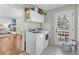 Laundry room with modern washer and dryer, storage cabinets, and access to the outdoors at 1522 N Pinebark Ln, Charleston, SC 29407