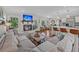 Cozy living room featuring a brick fireplace, a large sectional sofa, and an open view into the kitchen at 1522 N Pinebark Ln, Charleston, SC 29407