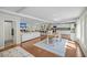 Open concept living room with fireplace, kitchen, dining area, and hardwood floors at 1522 N Pinebark Ln, Charleston, SC 29407