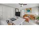 Office area showcasing a white desk setup, a leather couch, and ample storage with built-in closets at 1522 N Pinebark Ln, Charleston, SC 29407