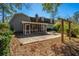 View of backyard with a screened porch, concrete patio, and outdoor dining set at 202 Hunt Club Dr, Summerville, SC 29485