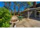 Concrete patio area with green metal table set and birdbath situated off screened porch at 202 Hunt Club Dr, Summerville, SC 29485