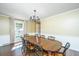 Formal dining room with a large wood table and elegant chandelier at 202 Hunt Club Dr, Summerville, SC 29485