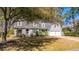 Captivating two-story home with dormer windows, a well-maintained lawn, and mature trees at 202 Hunt Club Dr, Summerville, SC 29485