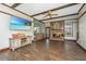 Inviting living room with a brick fireplace, wood-beamed ceiling, and stylish tile flooring at 202 Hunt Club Dr, Summerville, SC 29485