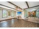 Warm and inviting living room with wood-beamed ceilings and tile flooring with seamless flow to dining at 202 Hunt Club Dr, Summerville, SC 29485