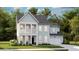 Charming two-story home featuring a covered porch, well-maintained landscaping, and an attached two-car garage at 204 Belfort Pl, Summerville, SC 29486