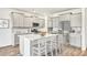 Bright kitchen features stainless appliances, center island with seating and stylish gray cabinets at 204 Belfort Pl, Summerville, SC 29486