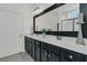 Bathroom vanity featuring double sinks, dark cabinets and a door to water closet at 209 Sea Lavender Ln, Summerville, SC 29486