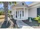 Inviting home entrance featuring decorative columns, landscaping, and charming front door at 209 Sea Lavender Ln, Summerville, SC 29486