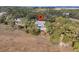 Aerial view of house with lush greenery and a glimpse of marsh views in the distance at 212 Chinaberry Ln, Kiawah Island, SC 29455