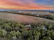 An aerial view of the sprawling property, surrounded by lush greenery and a peaceful waterway at 212 Chinaberry Ln, Kiawah Island, SC 29455