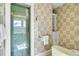 Beautiful bathroom with a butterfly-themed wallpaper, a shower and a sink with drawers at 212 Chinaberry Ln, Kiawah Island, SC 29455