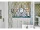 Classic bathroom featuring a butterfly-themed wallpaper and a vanity with a vessel sink and a gold framed mirror at 212 Chinaberry Ln, Kiawah Island, SC 29455