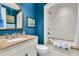Stylish blue bathroom featuring a marble vanity, classic fixtures, and a shower-tub combo at 212 Chinaberry Ln, Kiawah Island, SC 29455